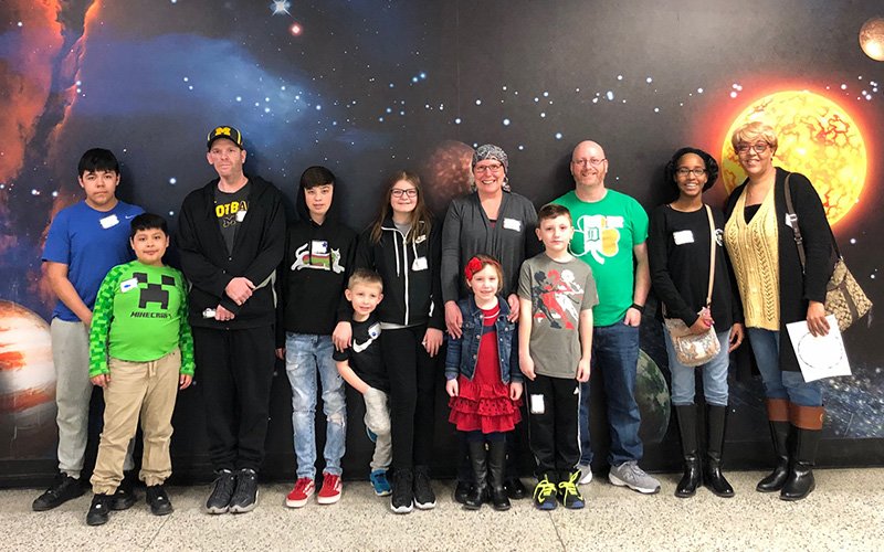 children with their parents at the planetarium