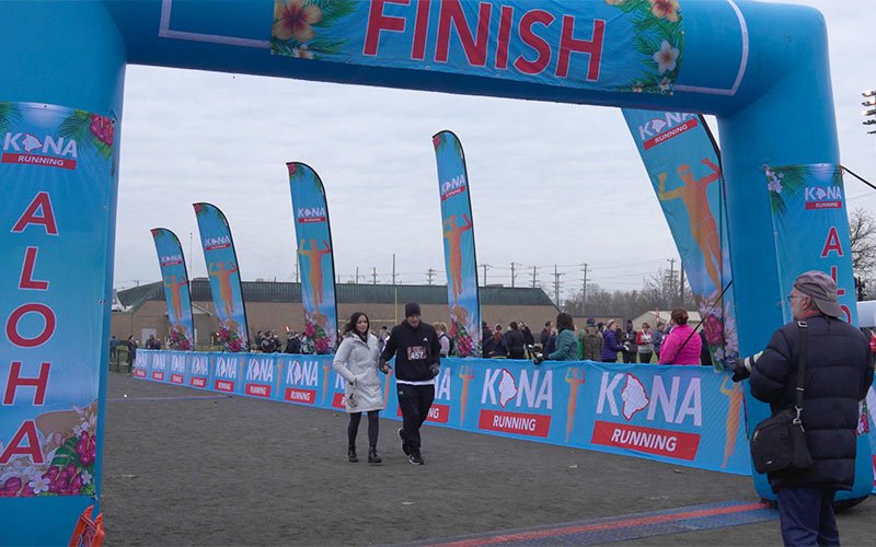 dennis crossing finish line