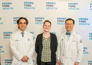 Combined Intestinal-Kidney Transplant recipient standing with transplant physicians