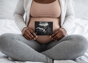 Pregnant woman holding sonogram. Getty Images