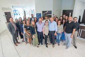 The Finsilver family poses for a photo with the OncoStat team in front of the new Shari and Stanley Finsilver and Family OncoStat sign in this photo provided by Henry Ford Health.	