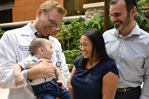 Neil S. Simmerman, M.D., Maris’ obstetrician and gynecologist and service chief for Women’s Health at Henry Ford West Bloomfield Hospital, holds Samuel Efrusy as his parents Maris and Nathan Efrusy look on. Maris recently reunited with the team that saved her life when she suffered an amniotic fluid embolism shortly after childbirth. 